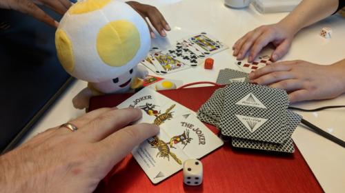 Players hands with plushie Toad (from Mario) and Cards