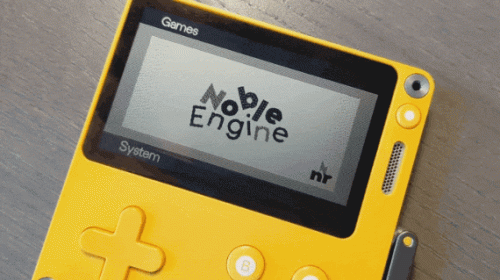 A photo of the Playdate, showing the logo for Noble Engine.