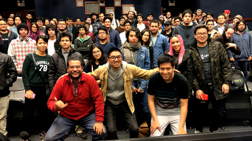 A group photo of a few dozen people smiling for the camera in auditorium seating, from an IGDA Peru event.