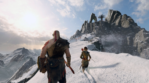 In a scene from the game God of War: Ragnarok, main character Kratos follows Atreus' lead as father and son hike up a snowy mountain.