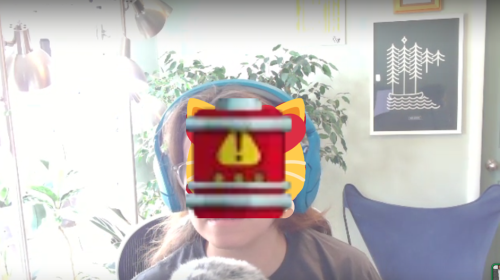 A screenshot of Ellen in a video call with a stack of custom emoji displayed in the center of the screen fully obscuring her face. This is a Discord bug.