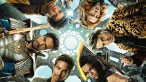 Characters from the D&D movie with their heads around a glowing circle