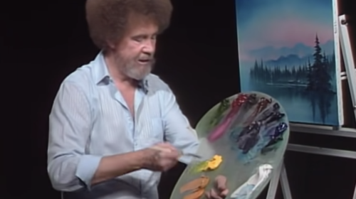 A picture of Bob Ross painting.