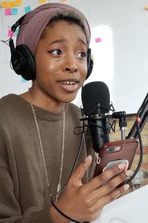 Adia recording a podcast episode