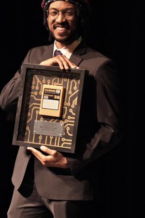 Picture of TImothy Staton-Davis holding an award.